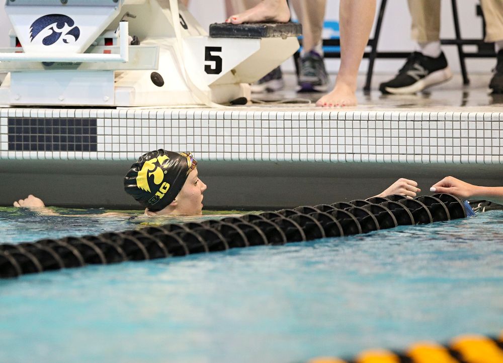 Iowa’s Macy Rink (from left) gets a fist bump from Penn State’s Camryn Barry after swimming the women’s 500 yard freestyle preliminary event during the 2020 Women’s Big Ten Swimming and Diving Championships at the Campus Recreation and Wellness Center in Iowa City on Thursday, February 20, 2020. (Stephen Mally/hawkeyesports.com)