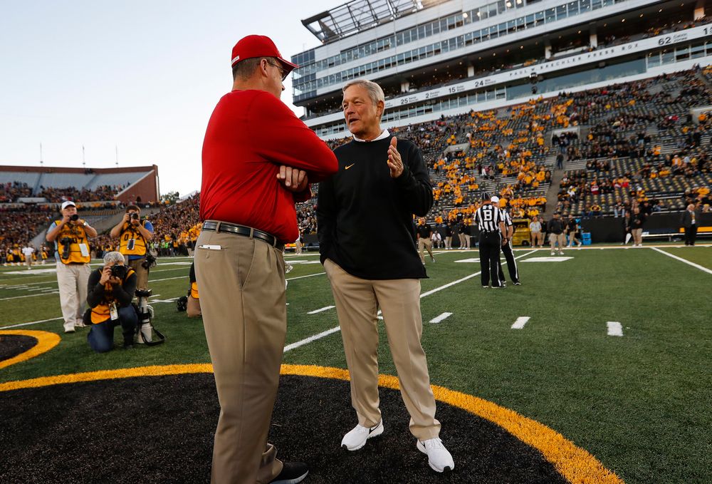 Iowa Hawkeyes head coach Kirk Ferentz meets with Wisconsin Badgers head coach Paul Chryst before a game against Wisconsin at Kinnick Stadium on September 22, 2018. (Tork Mason/hawkeyesports.com)