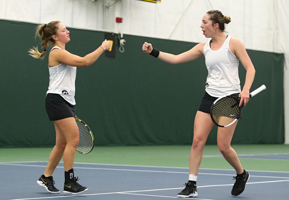 Iowa’s Danielle Burich (from left) and Samantha Mannix celebrate a point during her doubles match at the Hawkeye Tennis and Recreation Complex in Iowa City on Sunday, February 23, 2020. (Stephen Mally/hawkeyesports.com)