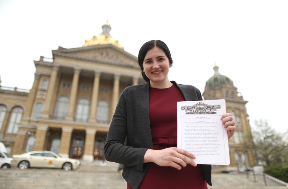 Iowa’s Megan Gustafson holds up a copy of the resolution by the general assembly honoring her outside of the at the Iowa State Capitol Wednesday, April 24, 2019 in Des Moines. (Brian Ray/hawkeyesports.com)