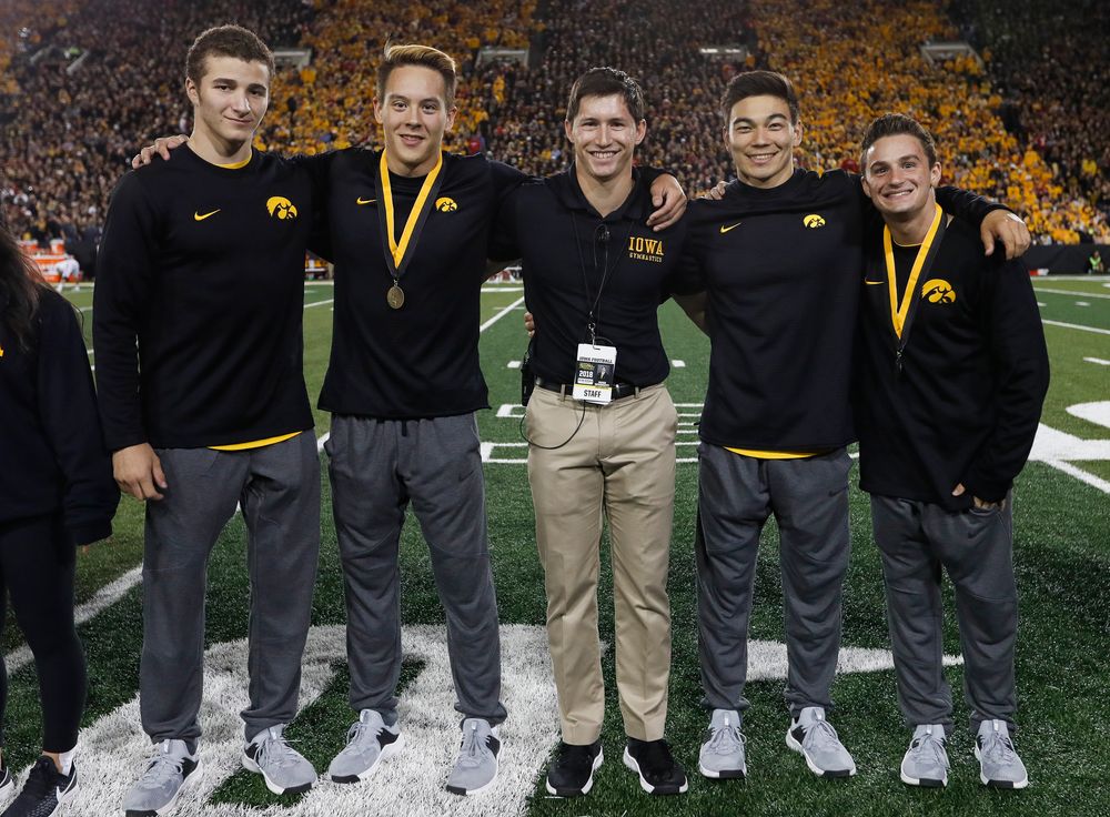 Members of the Iowa men's gymnastics team are recognized by the Presidential Committee on Athletics at halftime during a game against Wisconsin on September 22, 2018. (Tork Mason/hawkeyesports.com)