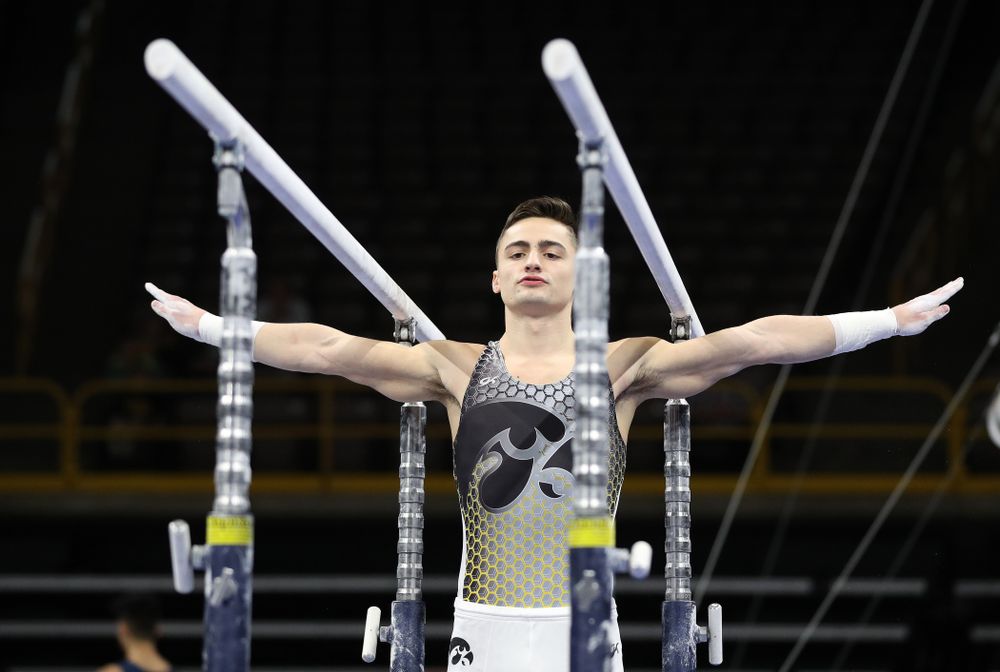 Iowa’s Mitch Mandozzi competes on the parallel bars against Illinois Sunday, March 1, 2020 at Carver-Hawkeye Arena. (Brian Ray/hawkeyesports.com)