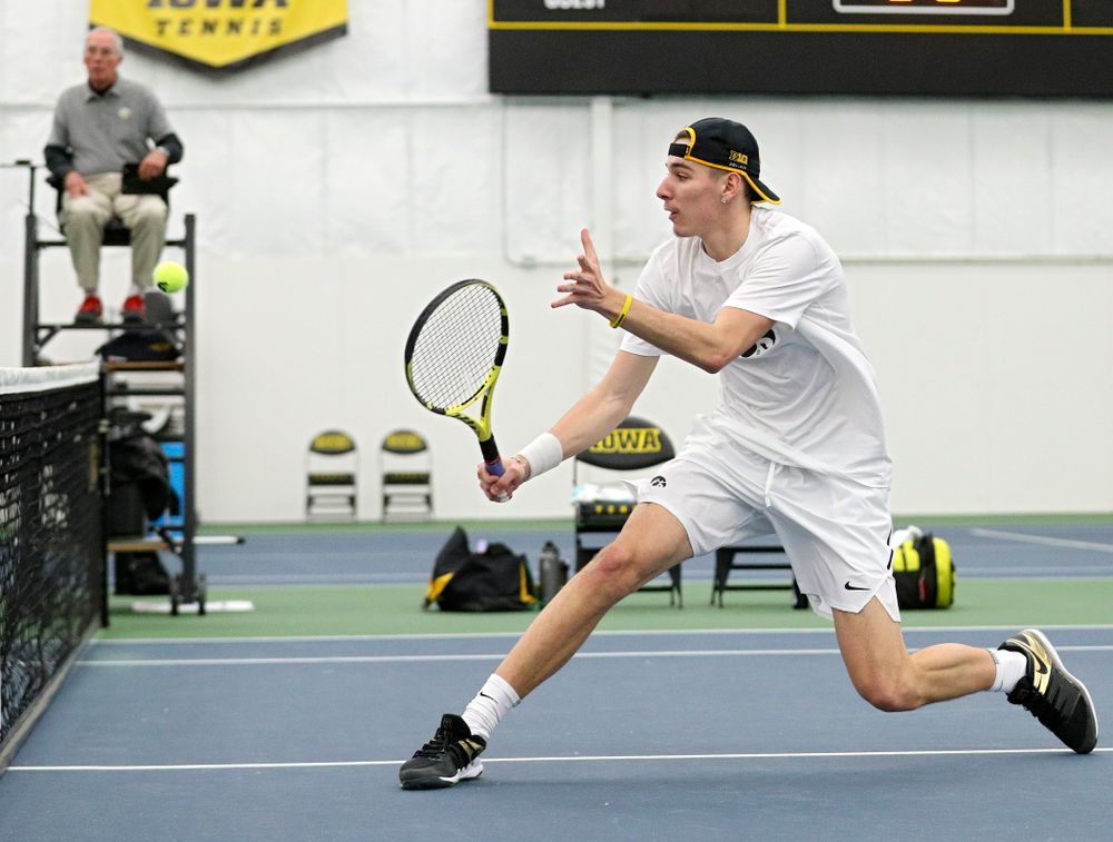 Iowa’s Nikita Snezhko returns a shot at the net during his doubles match at the Hawkeye Tennis and Recreation Complex in Iowa City on Sunday, February 16, 2020. (Stephen Mally/hawkeyesports.com)