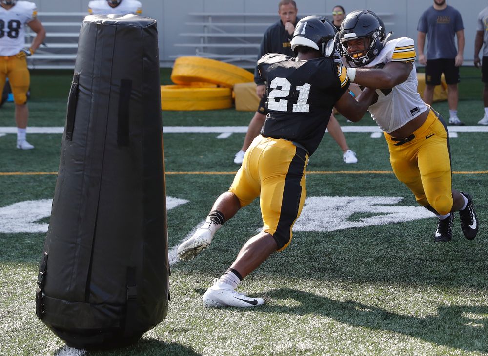 Iowa Hawkeyes running back Ivory Kelly-Martin (21) and linebacker Barrington Wade (35) during camp practice No. 17 Wednesday, August 22, 2018 at the Kenyon Football Practice Facility. (Brian Ray/hawkeyesports.com)