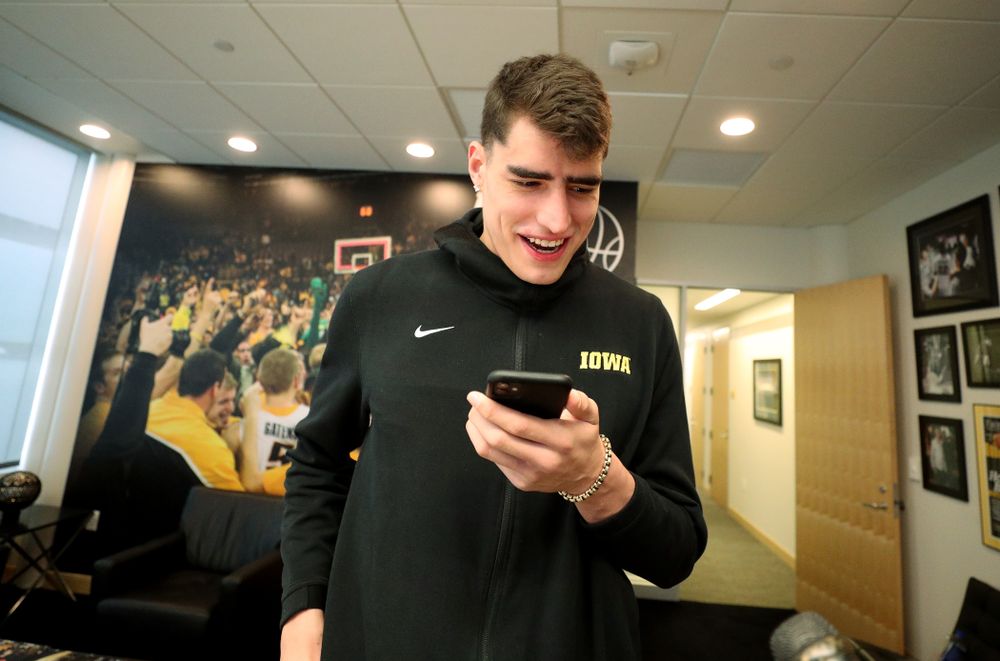 Iowa Hawkeyes forward Luka Garza (55) calls his dad after finding out that he has been named the Big Ten Player of the Year Monday, March 9, 2020 at Carver-Hawkeye Arena. (Brian Ray/hawkeyesports.com)