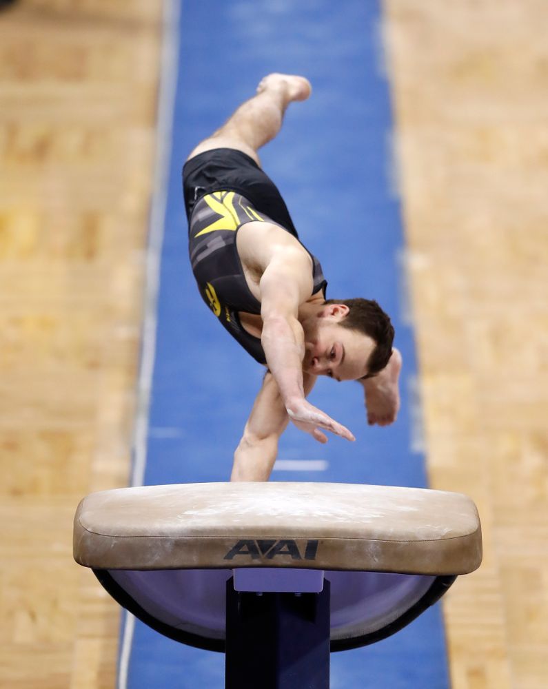 Dylan Ellsworth competes on the vault against Illinois 