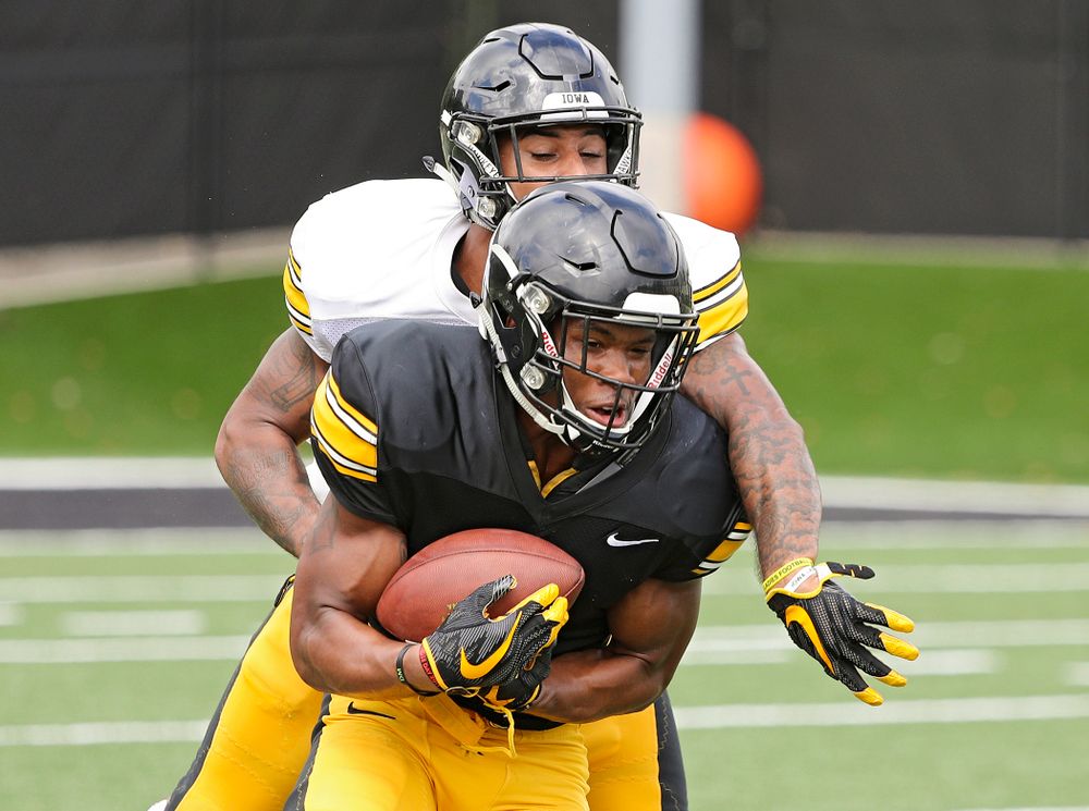 Iowa Hawkeyes wide receiver Tyrone Tracy Jr. (3) pulls in a pass as defensive back Geno Stone (9) defends during Fall Camp Practice No. 10 at the Hansen Football Performance Center in Iowa City on Tuesday, Aug 13, 2019. (Stephen Mally/hawkeyesports.com)