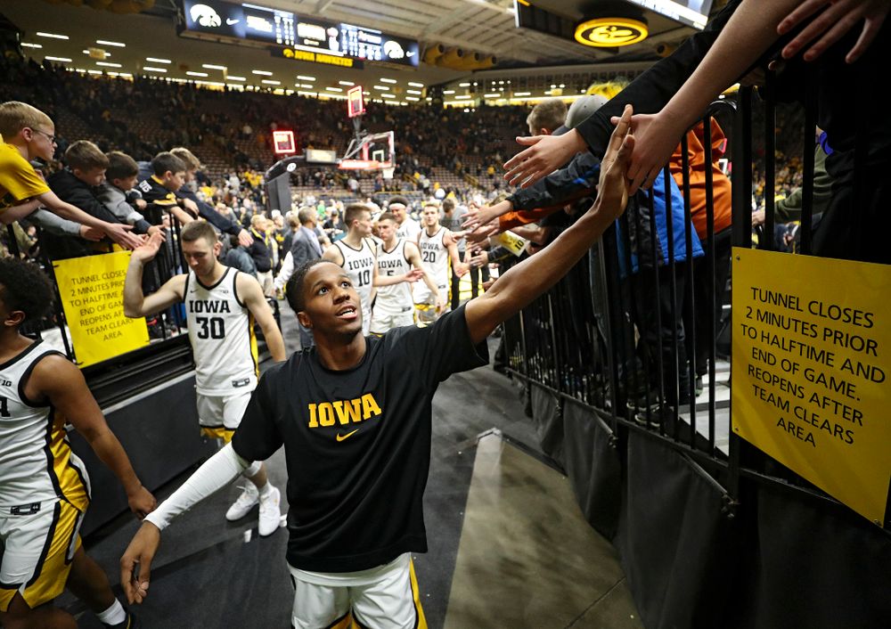 Iowa Hawkeyes guard Bakari Evelyn (4) greets fans after winning their their game at Carver-Hawkeye Arena in Iowa City on Sunday, December 29, 2019. (Stephen Mally/hawkeyesports.com)