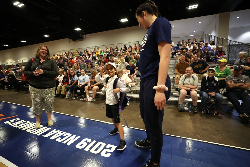 Iowa Hawkeyes forward Megan Gustafson (10) hugs a young fan at the Tourney Town Fan Fest Friday, April 5, 2019 at the Tampa Convention Center in Tampa, FL. (Brian Ray/hawkeyesports.com)