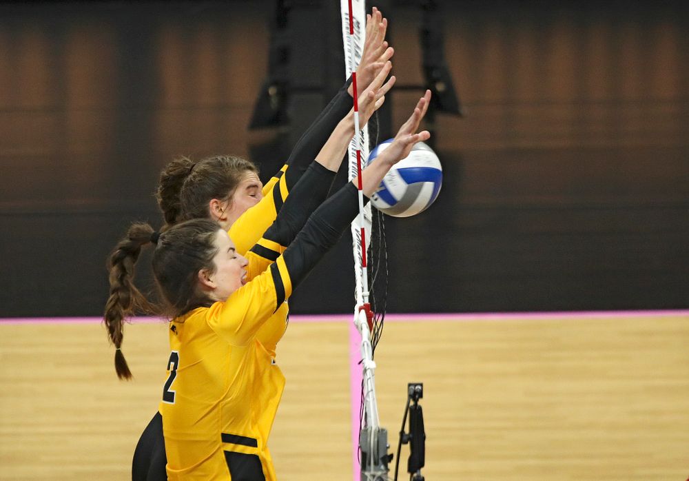 Iowa’s Blythe Rients (11) and Courtney Buzzerio (2) block a shot during their match at Carver-Hawkeye Arena in Iowa City on Sunday, Oct 20, 2019. (Stephen Mally/hawkeyesports.com)