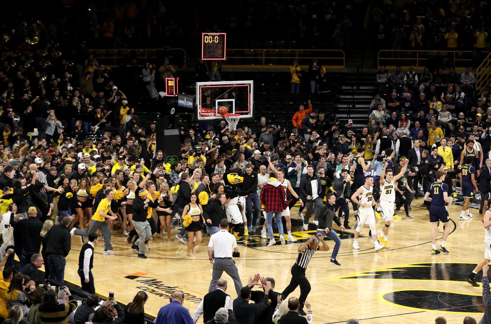Fans storm the court after Iowa Hawkeyes defeated the Michigan Wolverines  Friday, February 1, 2019 at Carver-Hawkeye Arena. (Brian Ray/hawkeyesports.com)