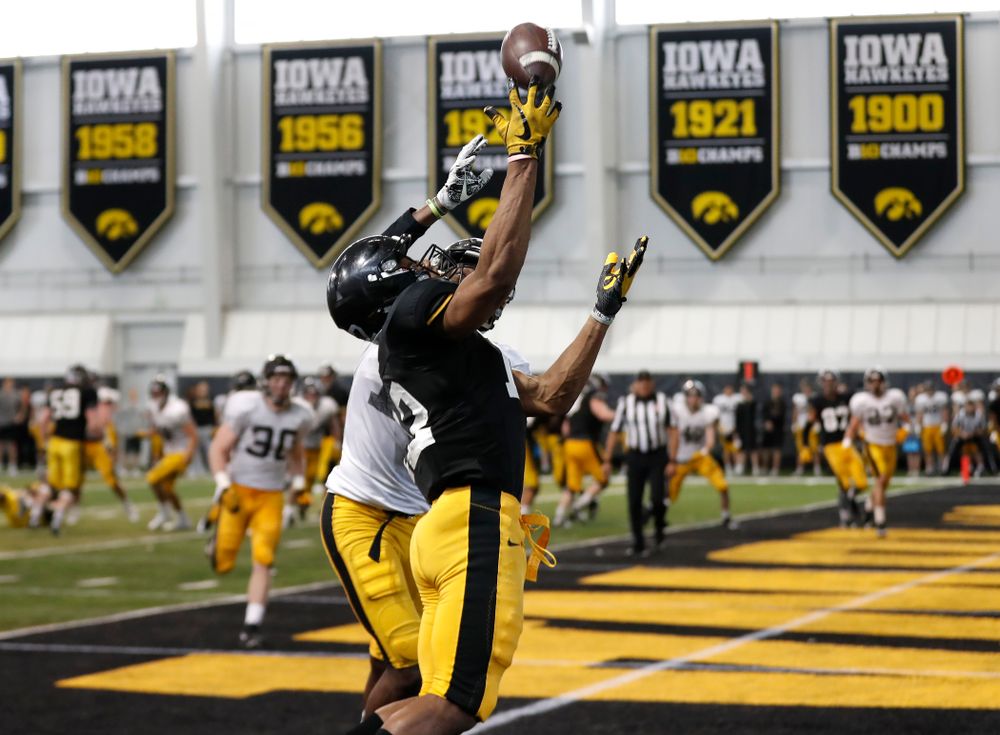 Iowa Hawkeyes wide receiver Brandon Smith (12) and defensive back Michael Ojemudia (11) during spring practice  Saturday, March 31, 2018 at the Hansen Football Performance Center. (Brian Ray/hawkeyesports.com)