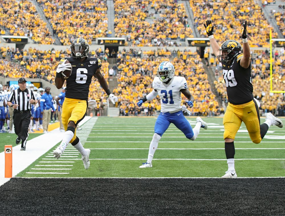Iowa Hawkeyes wide receiver Ihmir Smith-Marsette (6) crosses the goal line on a 14-yard touchdown run as tight end Nate Wieting (39) raises his arms during third quarter of their game at Kinnick Stadium in Iowa City on Saturday, Sep 28, 2019. (Stephen Mally/hawkeyesports.com)