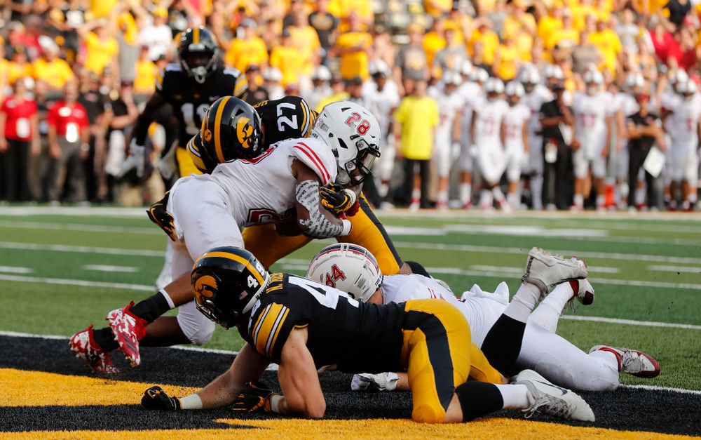 Iowa Hawkeyes defensive back Amani Hooker (27) stops Northern Illinois Huskies running back Jordan Nettles (28) in the end zone for a safety Saturday, September 1, 2018 at Kinnick Stadium. (Brian Ray/hawkeyesports.com)