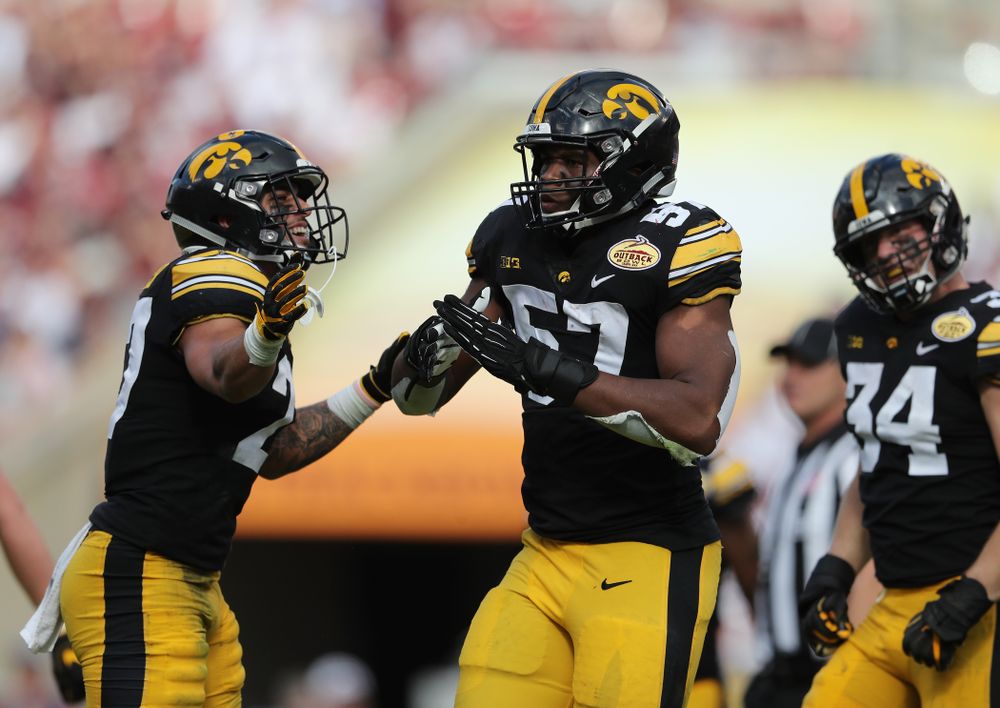 Iowa Hawkeyes defensive end Chauncey Golston (57) celebrates with defensive back Amani Hooker (27) after intercepting a pass during the Outback Bowl Tuesday, January 1, 2019 at Raymond James Stadium in Tampa, FL. (Brian Ray/hawkeyesports.com)