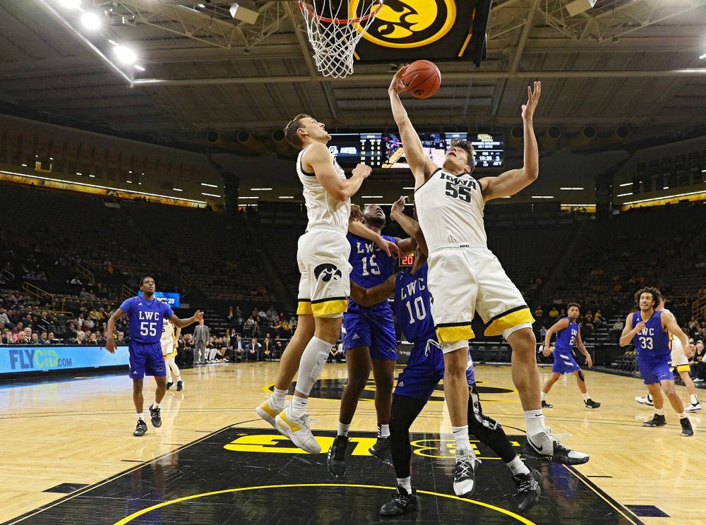 Iowa Hawkeyes center Luka Garza (55) pulls in an offensive rebound as forward Jack Nunge (left) looks on during the first half of their exhibition game against Lindsey Wilson College at Carver-Hawkeye Arena in Iowa City on Monday, Nov 4, 2019. (Stephen Mally/hawkeyesports.com)