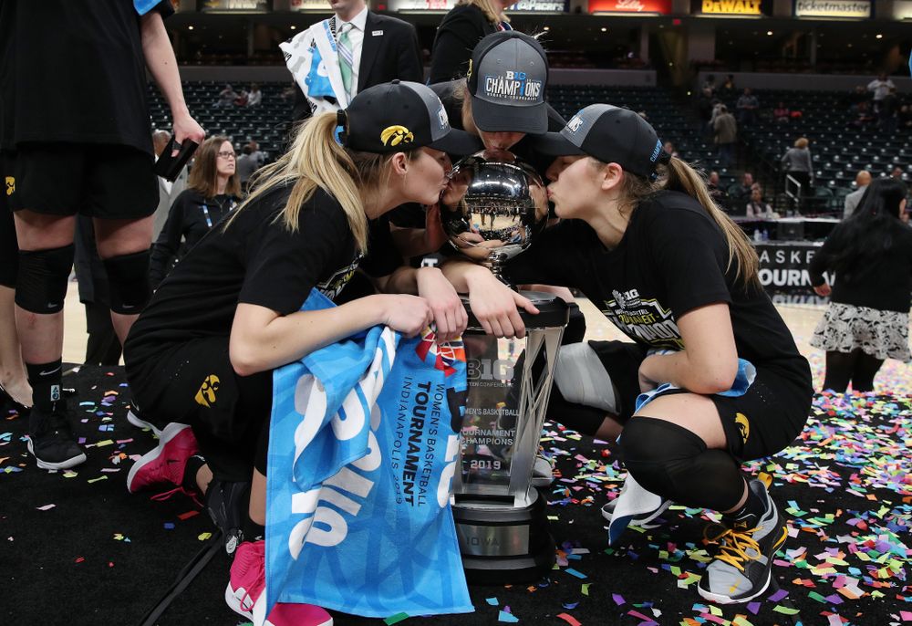 Iowa Hawkeyes guard Makenzie Meyer (3), forward Hannah Stewart (21), and guard Kathleen Doyle (22) celebrate their win against the Maryland Terrapins Sunday, March 10, 2019 at Bankers Life Fieldhouse in Indianapolis, Ind. (Brian Ray/hawkeyesports.com)