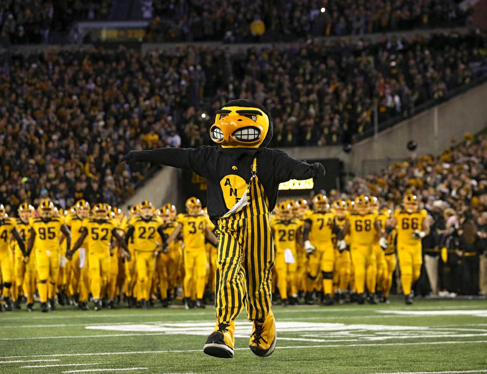 Herky leads the Hawkeyes as they swarm to take the field before their game at Kinnick Stadium in Iowa City on Saturday, Oct 12, 2019. (Stephen Mally/hawkeyesports.com)