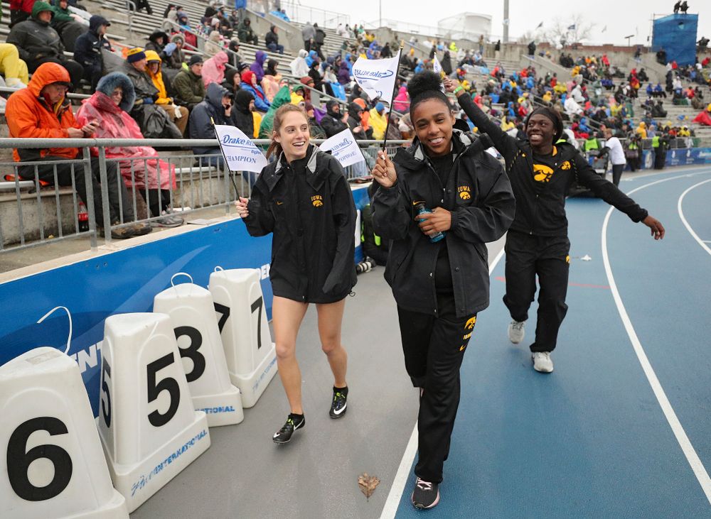Iowa's Talia Buss, Briana Guillory, Taylor Arco (behind), and Antonise Christian take a victory lap after winning the women's sprint medley relay event during the third day of the Drake Relays at Drake Stadium in Des Moines on Saturday, Apr. 27, 2019. (Stephen Mally/hawkeyesports.com)