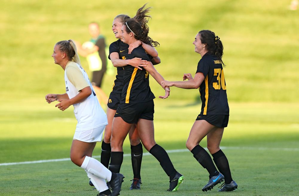Iowa forward Jenny Cape (left) and forward Devin Burns (right) celebrate with Kaleigh Haus (center) after her goal during the first half of their match against Western Michigan at the Iowa Soccer Complex in Iowa City on Thursday, Aug 22, 2019. (Stephen Mally/hawkeyesports.com)