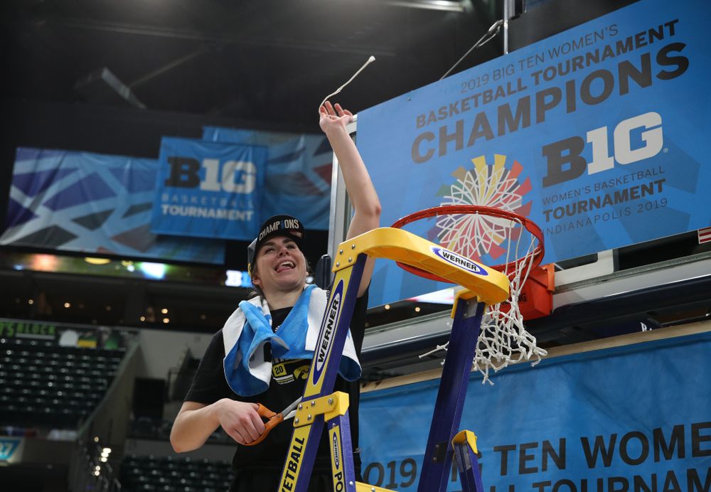 Iowa Hawkeyes forward Hannah Stewart (21) cuts down the net as they celebrate their victory over the Maryland Terrapins in the Big Ten Championship Game Sunday, March 10, 2019 at Bankers Life Fieldhouse in Indianapolis, Ind. (Brian Ray/hawkeyesports.com)