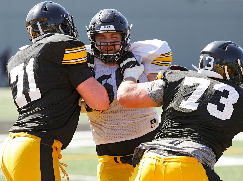 Iowa Hawkeyes defensive lineman Dalles Jacobus (center) works between offensive lineman Mark Kallenberger (71) and offensive lineman Cody Ince (73) during Fall Camp Practice #5 at the Hansen Football Performance Center in Iowa City on Tuesday, Aug 6, 2019. (Stephen Mally/hawkeyesports.com)