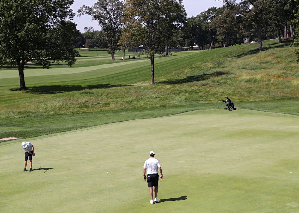 Iowa’s Matthew Garside (from left) putts as head coach Tyler Stith looks on during the second day of the Golfweek Conference Challenge at the Cedar Rapids Country Club in Cedar Rapids on Monday, Sep 16, 2019. (Stephen Mally/hawkeyesports.com)