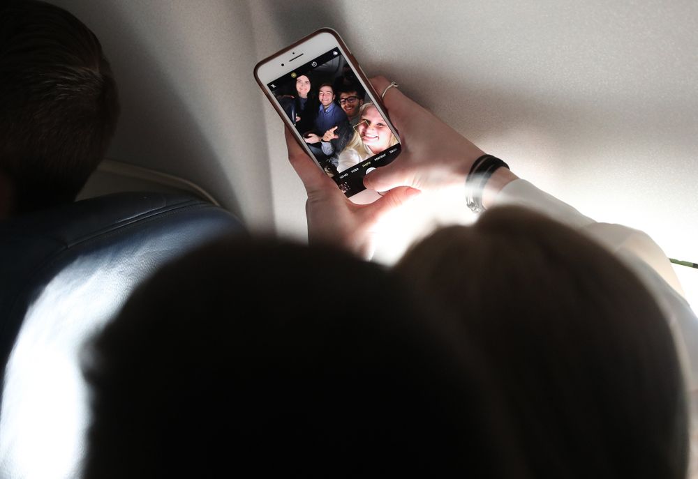 Iowa Hawkeyes forward Megan Gustafson (10) takes selfies with the band and spirit squad on board the team plane to Greensboro, NC for the Regionals of the 2019 NCAA Women's Basketball Championships Thursday, March 28, 2019 at the Eastern Iowa Airport. (Brian Ray/hawkeyesports.com)