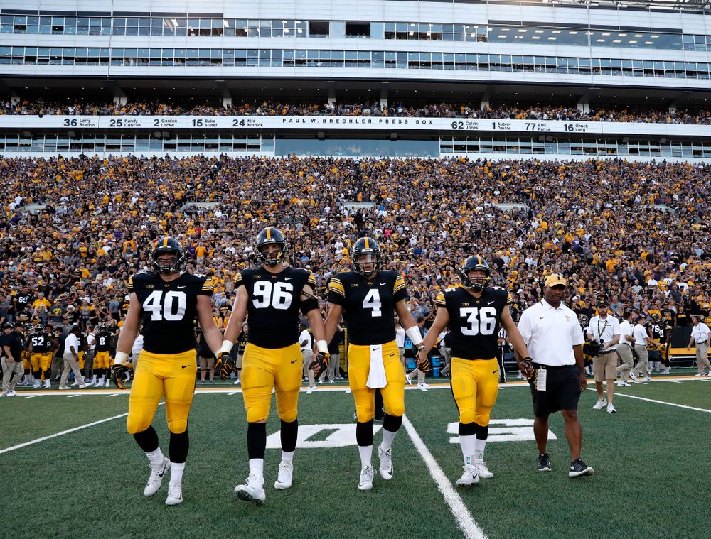 Captains Iowa Hawkeyes defensive end Parker Hesse (40), defensive end Matt Nelson (96), quarterback Nate Stanley (4), fullback Brady Ross (36) and honorary captain Marvin Sims, Jr. against the Northern Iowa Panthers Saturday, September 15, 2018 at Kinnick Stadium. (Brian Ray/hawkeyesports.com)