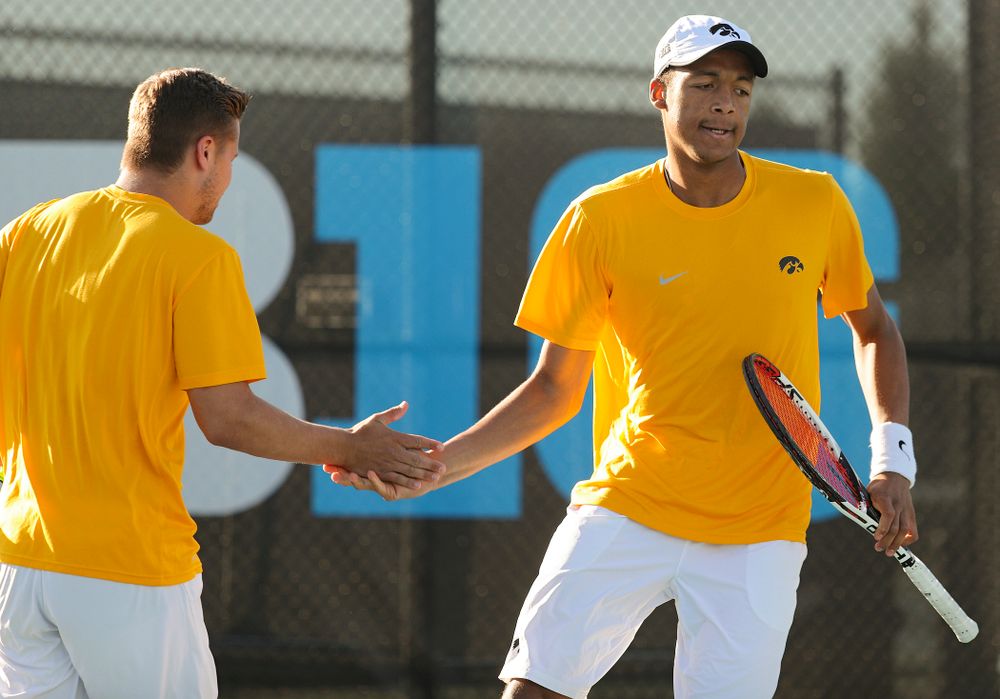 Iowa's Will Davies (from left) and Oliver Okonkwo celebrate a point during their doubles match again Michigan State at the Hawkeye Tennis and Recreation Complex in Iowa City on Friday, Apr. 19, 2019. (Stephen Mally/hawkeyesports.com)