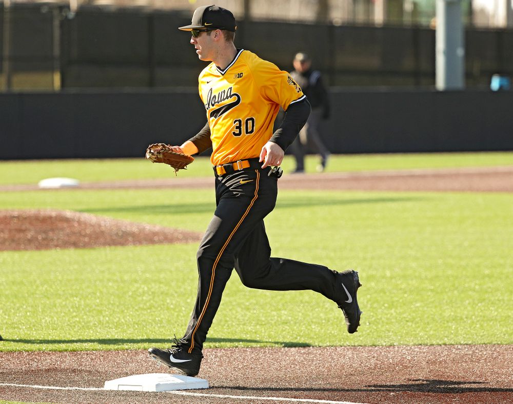 Iowa Hawkeyes first baseman Connor McCaffery (30) steps on first base for an out after fielding a ground ball during the first inning of their game at Duane Banks Field in Iowa City on Tuesday, Apr. 2, 2019. (Stephen Mally/hawkeyesports.com)