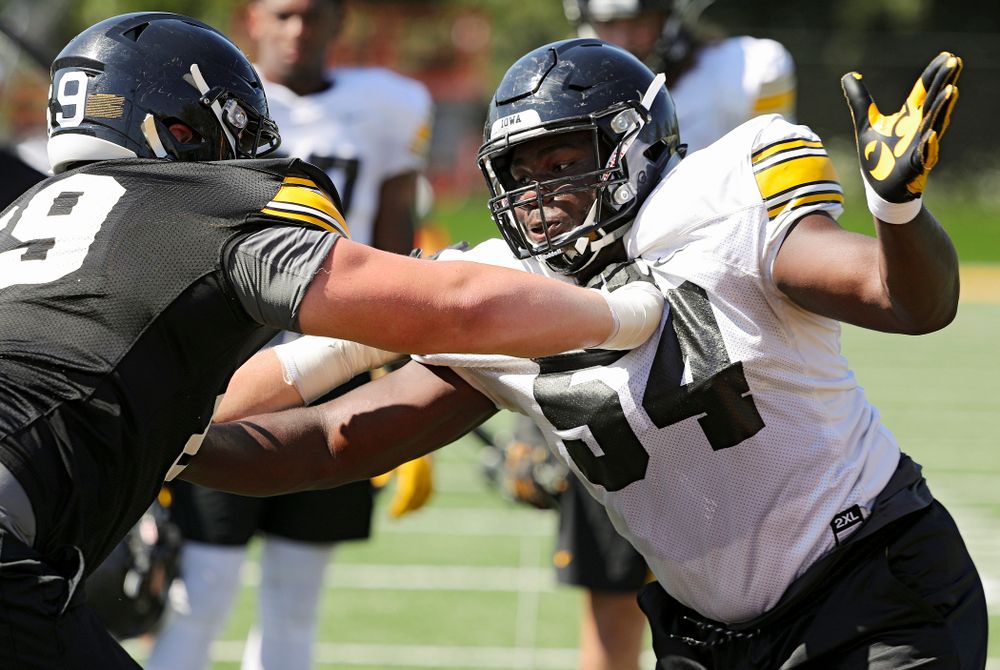 Iowa Hawkeyes defensive tackle Daviyon Nixon (54) tries to get around offensive lineman Tyler Endres (69) during Fall Camp Practice No. 7 at the Hansen Football Performance Center in Iowa City on Friday, Aug 9, 2019. (Stephen Mally/hawkeyesports.com)