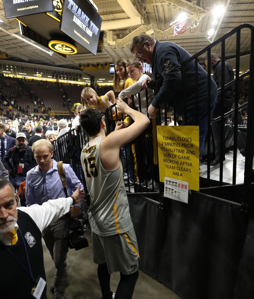 Iowa Hawkeyes forward Ryan Kriener (15) talks with Mike Street and family following their game against the Nebraska Cornhuskers Sunday, January 6, 2019 at Carver-Hawkeye Arena. (Brian Ray/hawkeyesports.com)