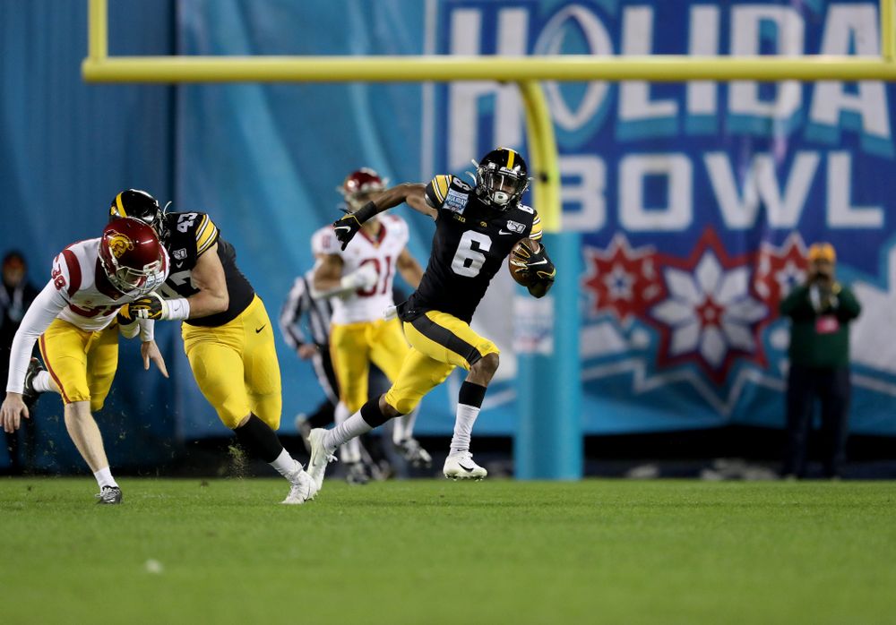 Iowa Hawkeyes wide receiver Ihmir Smith-Marsette (6) returns a kick for a touchdown against USC in the Holiday Bowl Friday, December 27, 2019 at San Diego Community Credit Union Stadium.  (Brian Ray/hawkeyesports.com)