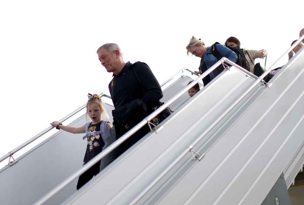 Iowa Hawkeyes head coach Kirk Ferentz disembarks the team plane with his grand daughter after arriving in San Diego, CA Saturday, December 21, 2019 for the Holiday Bowl. (Brian Ray/hawkeyesports.com)