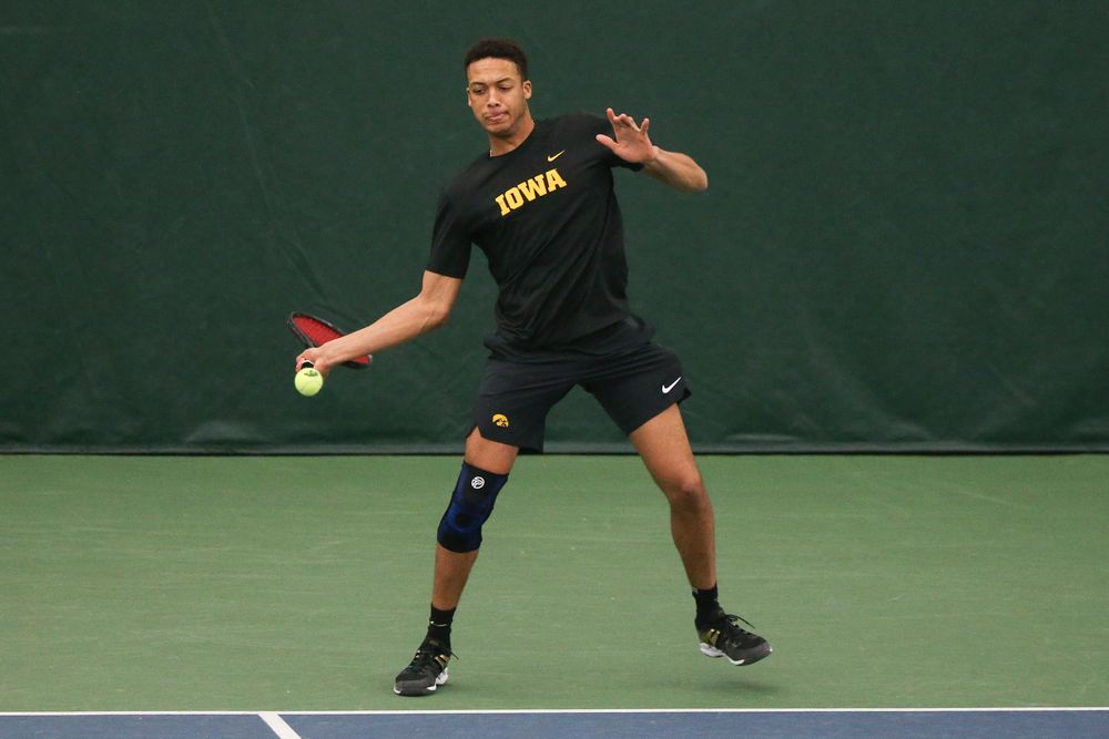 Iowa’s Oliver Okonkwo returns a hit during the Iowa men’s tennis meet vs VCU  on Saturday, February 29, 2020 at the Hawkeye Tennis and Recreation Complex. (Lily Smith/hawkeyesports.com)