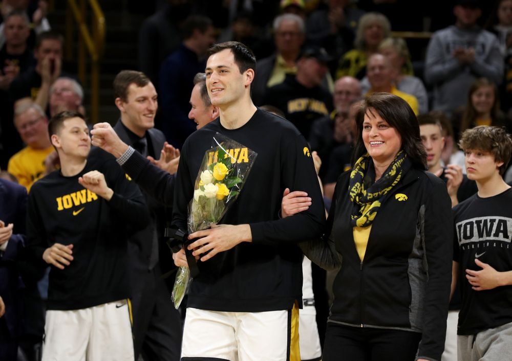 Iowa Hawkeyes forward Ryan Kriener (15) hold up his jersey during senior night activities before their game against the Purdue Boilermakers Tuesday, March 3, 2020 at Carver-Hawkeye Arena. (Brian Ray/hawkeyesports.com)