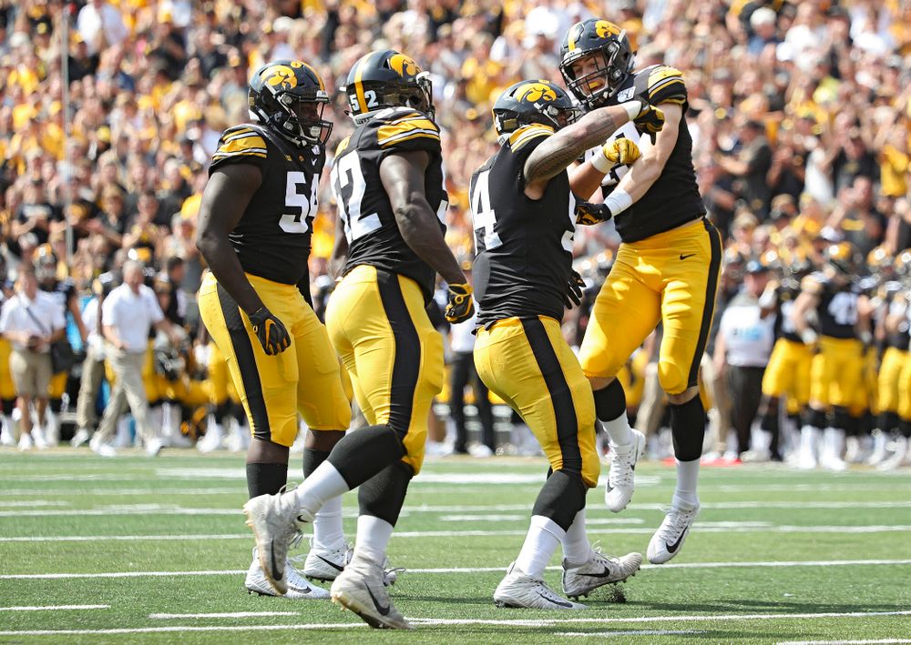 Iowa Hawkeyes defensive tackle Daviyon Nixon (54), linebacker Amani Jones (52), defensive end A.J. Epenesa (94), and linebacker Nick Niemann (49) celebrate after a sack during the second quarter of their Big Ten Conference football game at Kinnick Stadium in Iowa City on Saturday, Sep 7, 2019. (Stephen Mally/hawkeyesports.com)
