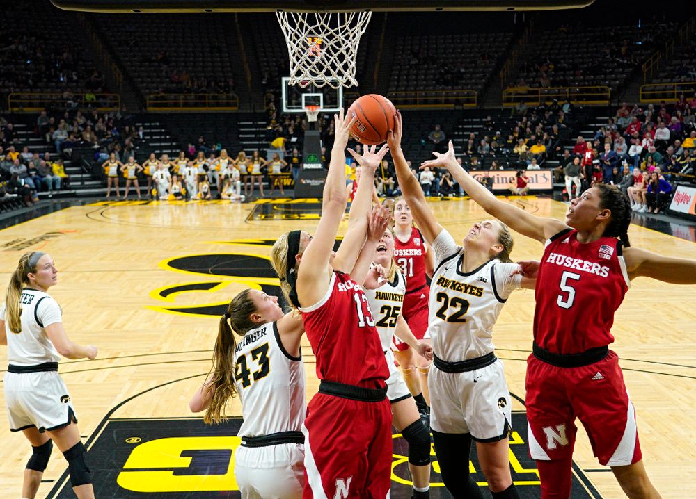 Iowa Hawkeyes forward Amanda Ollinger (43), forward Monika Czinano (25), and guard Kathleen Doyle (22) battle for a rebound during the second quarter of the game at Carver-Hawkeye Arena in Iowa City on Thursday, February 6, 2020. (Stephen Mally/hawkeyesports.com)