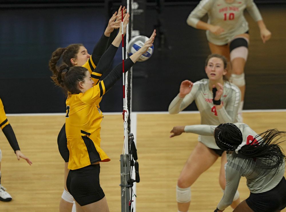 Iowa’s Blythe Rients (11) and Courtney Buzzerio (2) block a shot during the third set of their match at Carver-Hawkeye Arena in Iowa City on Friday, Nov 29, 2019. (Stephen Mally/hawkeyesports.com)