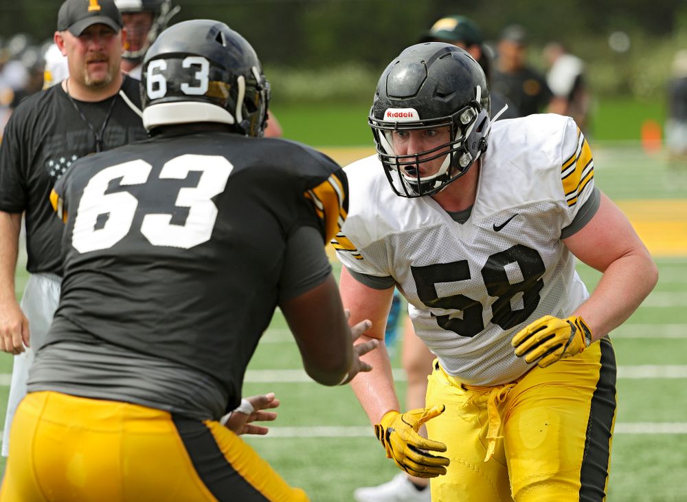 Iowa Hawkeyes offensive lineman Justin Britt (63) and Taylor Fox (58) run a drill during Fall Camp Practice No. 10 at the Hansen Football Performance Center in Iowa City on Tuesday, Aug 13, 2019. (Stephen Mally/hawkeyesports.com)