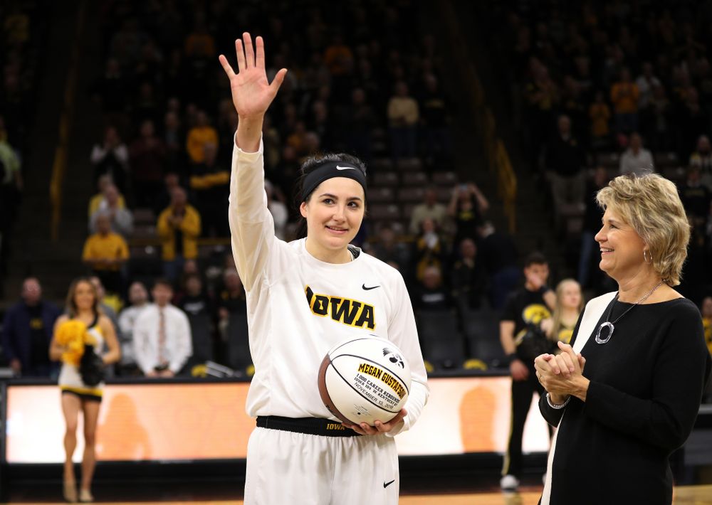 Iowa Hawkeyes forward Megan Gustafson (10) revives a ball commemorating her 1,00th career rebound from Iowa Hawkeyes head coach Lisa Bluder during their game against the IUPUI Jaguars Saturday, December 8, 2018 at Carver-Hawkeye Arena. (Brian Ray/hawkeyesports.com)