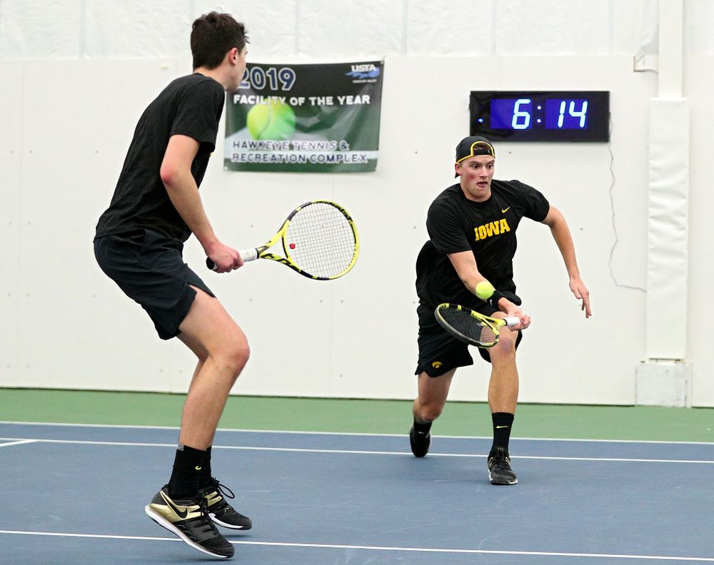 Iowa’s Joe Tyler (right) returns a shot as Matt Clegg looks on during their doubles match at the Hawkeye Tennis and Recreation Complex in Iowa City on Friday, February 14, 2020. (Stephen Mally/hawkeyesports.com)