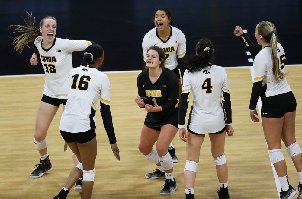 Iowa Hawkeyes middle blocker Hannah Clayton (18), Iowa Hawkeyes setter Brie Orr (7) and Iowa Hawkeyes defensive specialist Molly Kelly (1) celebrate after winning a point during a match against Penn State at Carver-Hawkeye Arena on November 3, 2018. (Tork Mason/hawkeyesports.com)