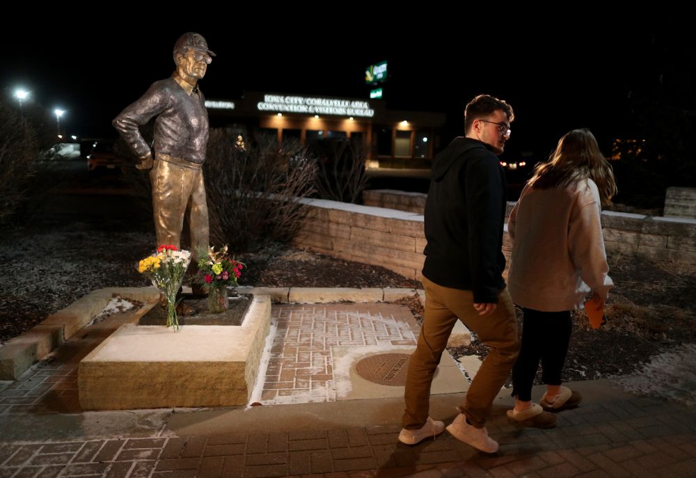 Mourners lay flowers at the statue of former Hawkeye Football Head Coach Hayden Fry Tuesday, December 17, 2019 in Coralville. Fry passed away on Tuesday at the age of 90. (Brian Ray/hawkeyesports.com)