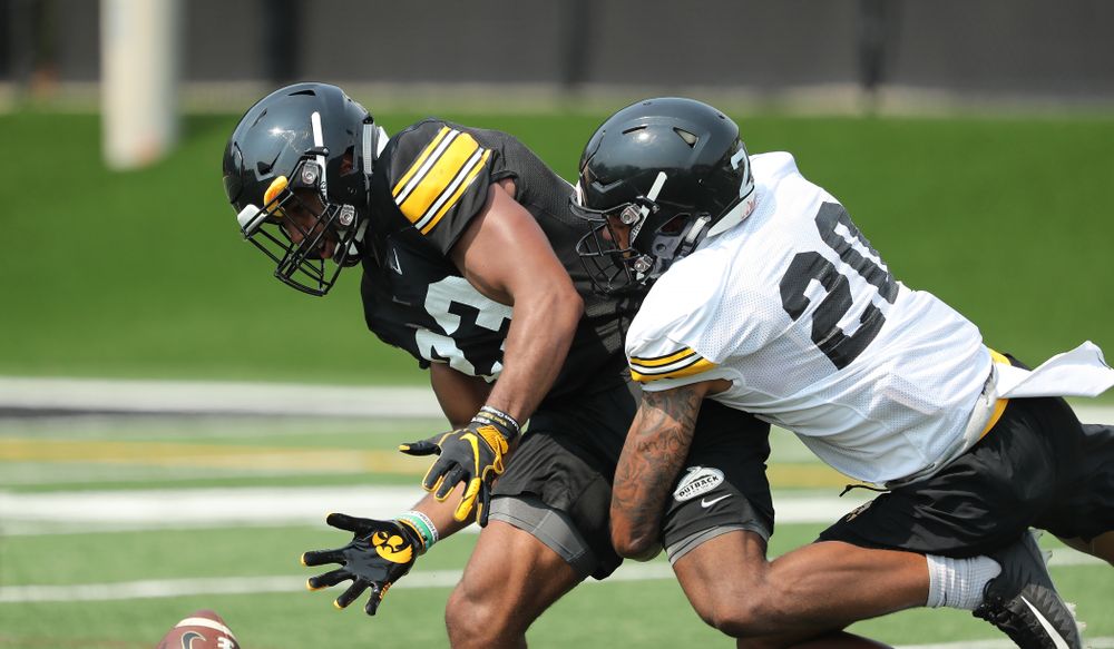 Iowa Hawkeyes wide receiver Dominique Dafney (23) and defensive back Julius Brents (20)