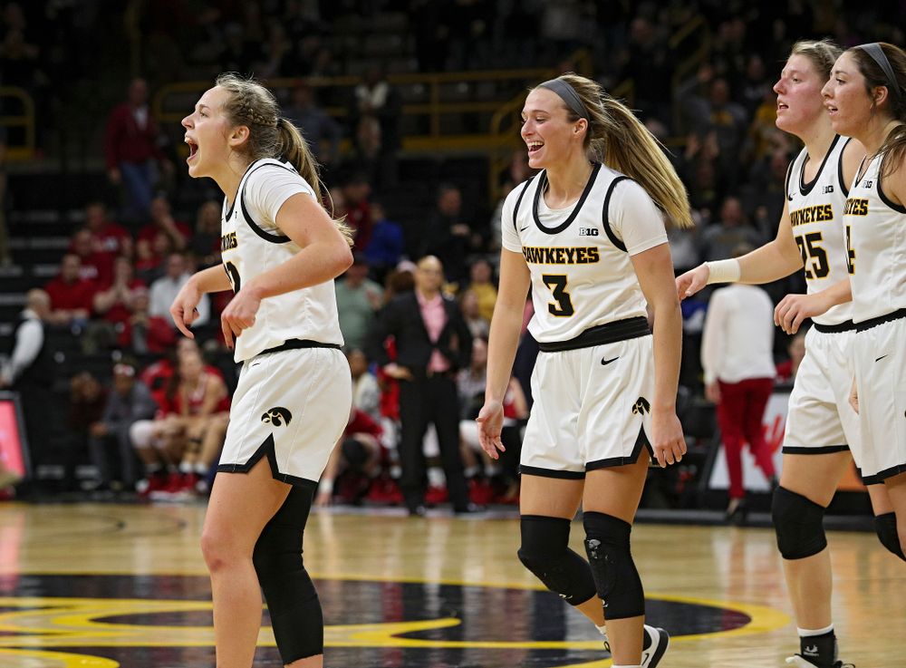 Iowa Hawkeyes guard Kathleen Doyle (22) celebrates with guard Makenzie Meyer (3), forward Monika Czinano (25), and guard Mckenna Warnock (14),  after making a basket while being fouled during the fourth quarter of their game at Carver-Hawkeye Arena in Iowa City on Sunday, January 12, 2020. (Stephen Mally/hawkeyesports.com)