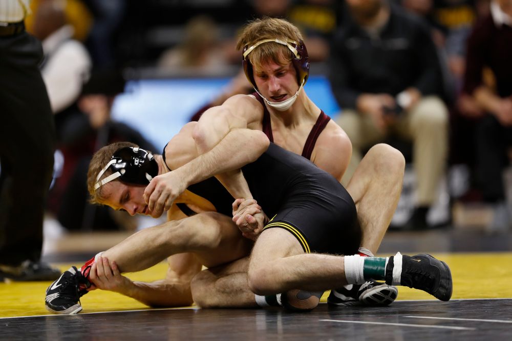 Iowa's Carter Happel wrestles Minnesota's Tommy Thorn at 141 pounds