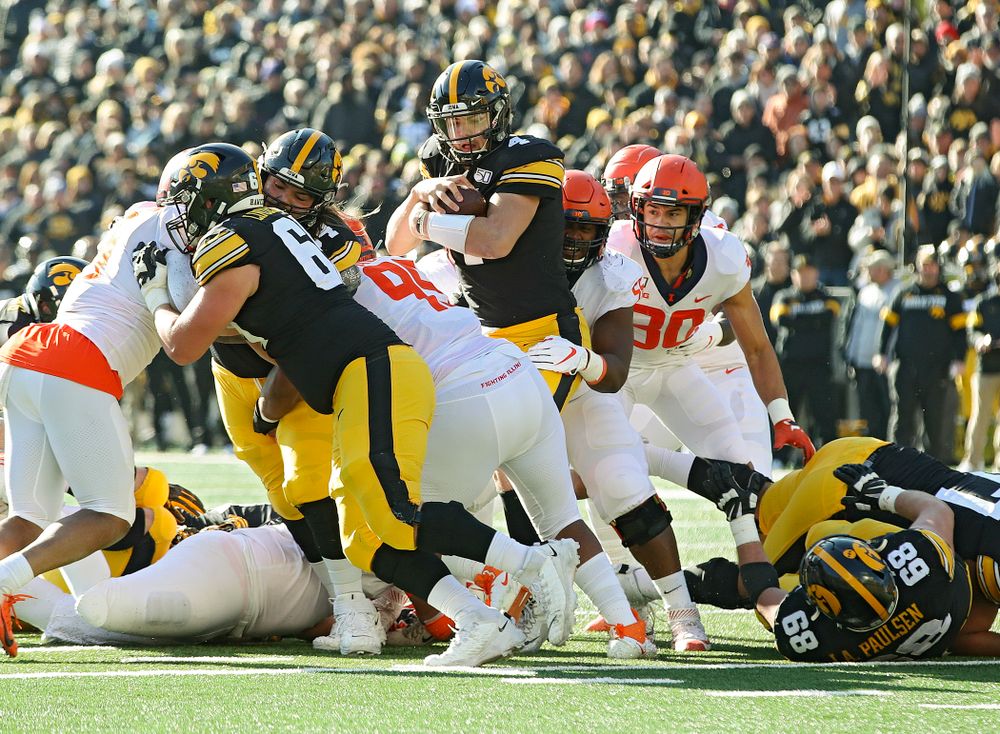 Iowa Hawkeyes quarterback Nate Stanley (4) runs for a first down during the second quarter of their game at Kinnick Stadium in Iowa City on Saturday, Nov 23, 2019. (Stephen Mally/hawkeyesports.com)