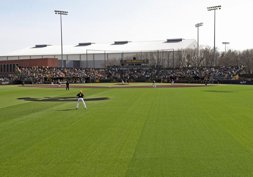 Fans look on as the Iowa Hawkeyes field during the eighth inning of their game against Rutgers at Duane Banks Field in Iowa City on Saturday, Apr. 6, 2019. (Stephen Mally/hawkeyesports.com)